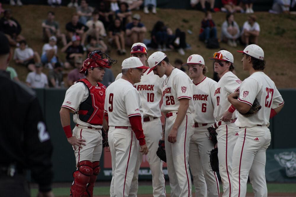Sophomore pitcher Cooper Consiglio looks unhappy while speaking to head coach Elliott Avent during the game against USC-Upstate on Doak Field at Dail Park on Tuesday, March 25, 2025. The game ended in the eighth inning due to the mercy rule.&#160;The Wolfpack lost to the Spartans 15-5.