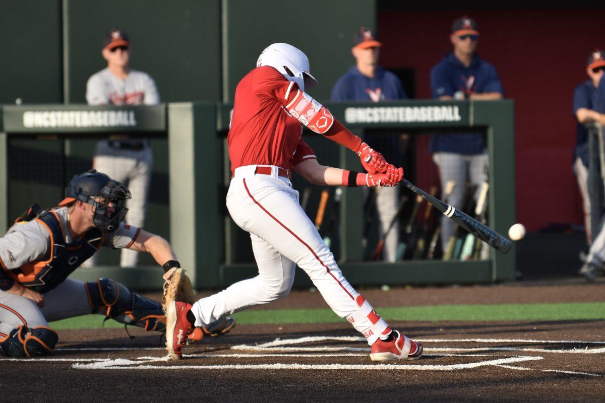 Sophomore catcher Alex Sosa hits during the Wolfpack's home game against the Virginia Cavaliers on Doak Field at Dail Park on Friday, April 4, 2025. Sosa had one hit for one run and one runner batted in. The Cavaliers beat the Wolfpack 8-6 to take the first game of the series.
