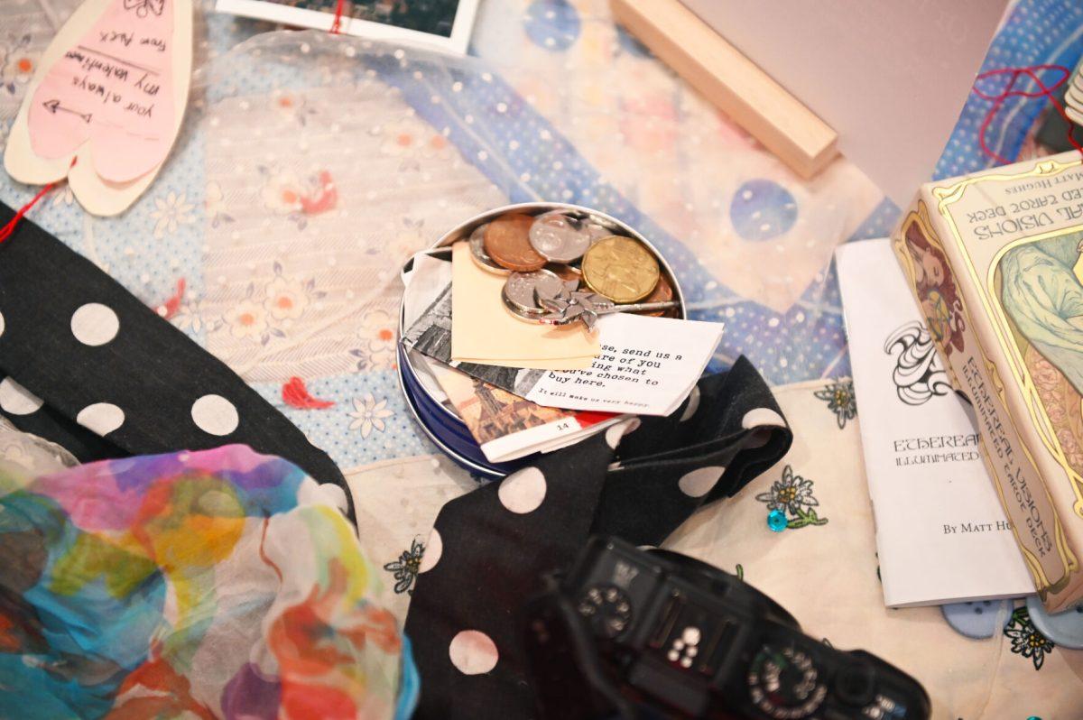 Mementos and childhood keepsakes sit on a table as part of the piece, &#8220;Ornaments of Being&#8221; by Sophie Dickerson, a fourth-year studying graphic and experience design, during the Art2Wear: Revive! show at the Gregg Museum of Art and Design on Thursday, April 24, 2025. Dickerson&#8217;s piece uses neuron branches decorated with childhood photos and memorabilia to revive memories of her past.