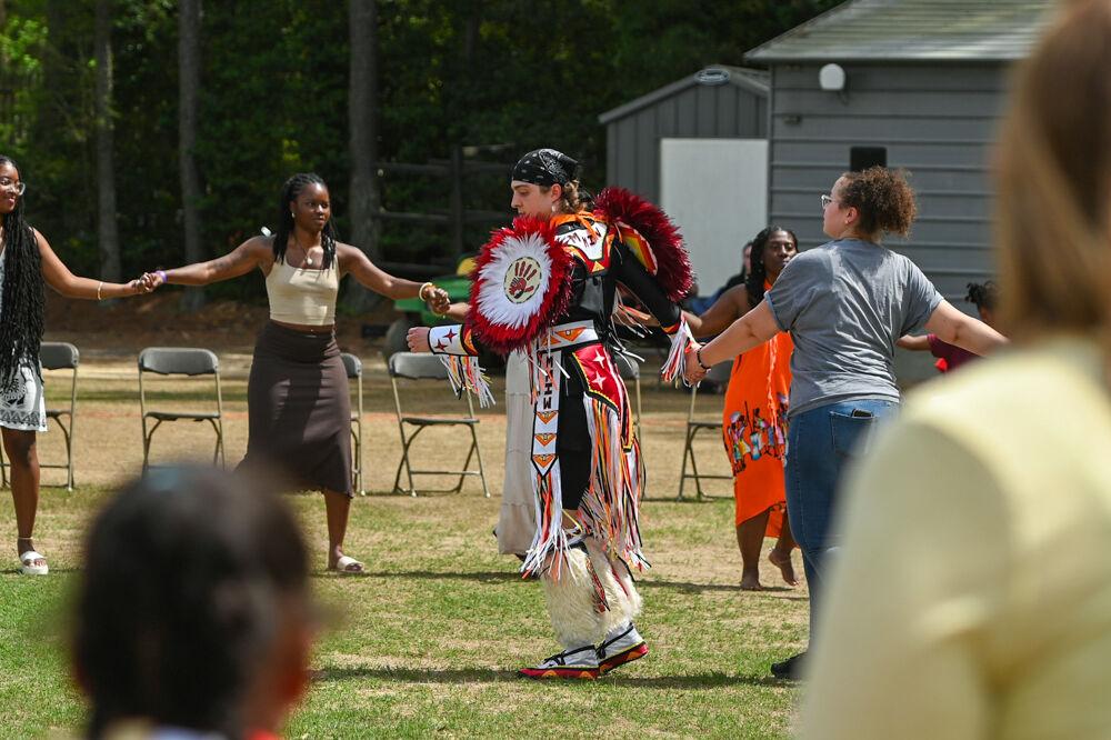 Caleb Hedgepeth, wearing his regalia, leads visitors and dancers in a Circle Dance during NC State's 35th Annual Powwow at Miller Fields on Saturday, April 5, 2025. The event featured displays of different Indigenous dance styles accompanied by traditional drum groups.