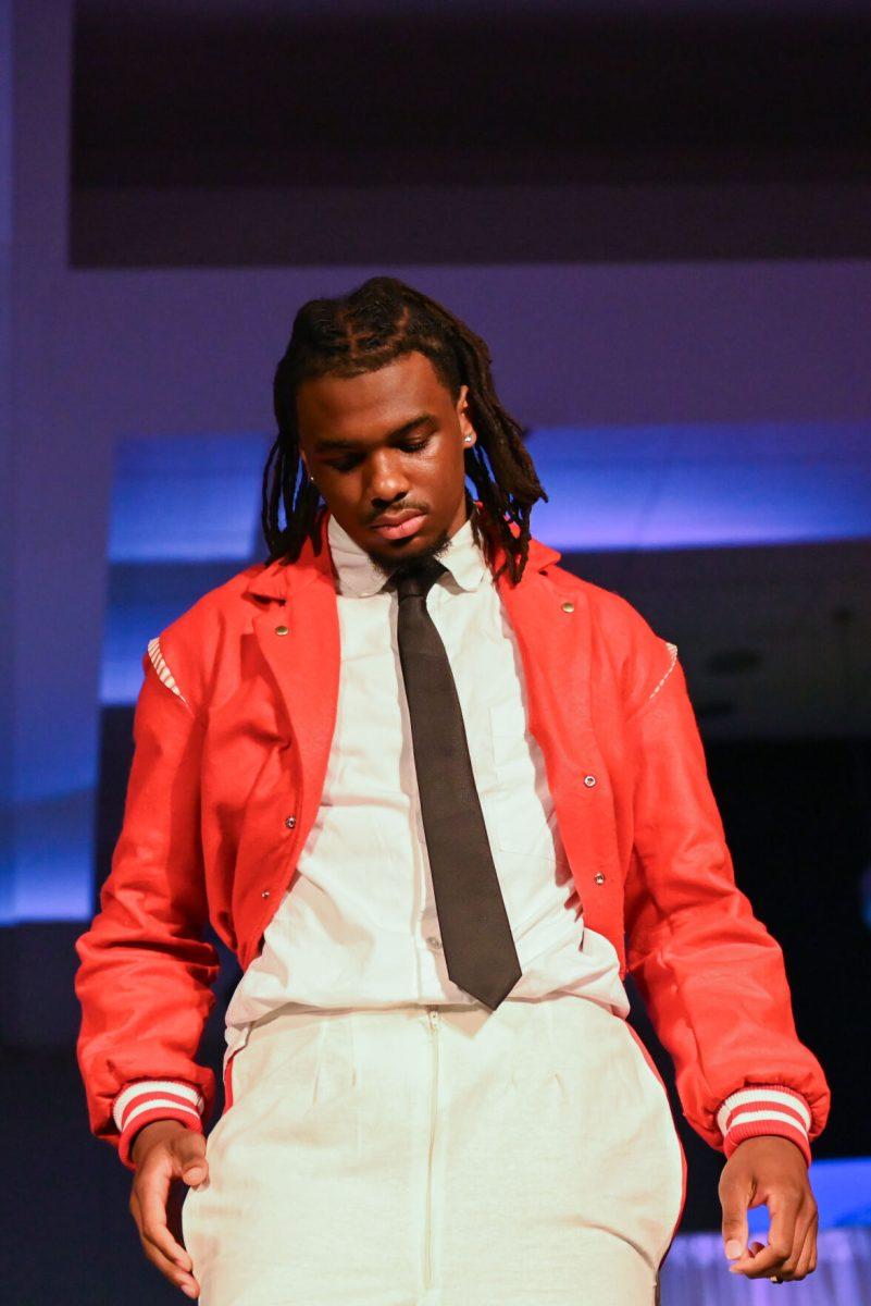 A model looks down while posing at the end of the runway wearing an outfit from Layla Nichols's collection, "Classically Refreshed," during the 27th Annual Fashion Expose at Talley Student Union on Thursday, April 10, 2025. The event, hosted by the NC State Wilson College of Textiles African American Textile Society, highlighted the hard work of students in various skill categories: novice, intermediate and beyond.