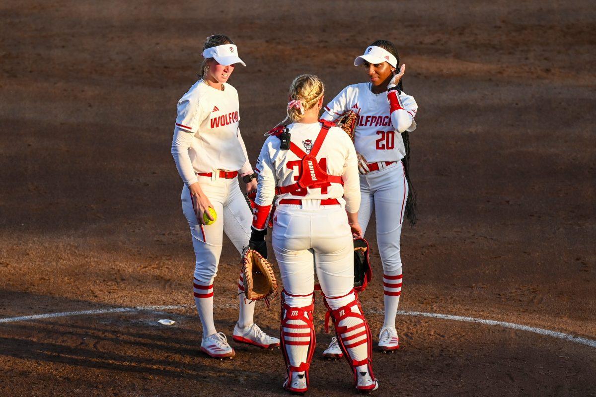Junior pitcher Rylee Wyman (left), redshirt senior catcher Payden Bordeau (center) and junior utility player MaKayla Marbury (right) speak during the game against Virginia Tech at Dail Softball Stadium on Friday, April 5, 2025. NC State lost the game 10-2.