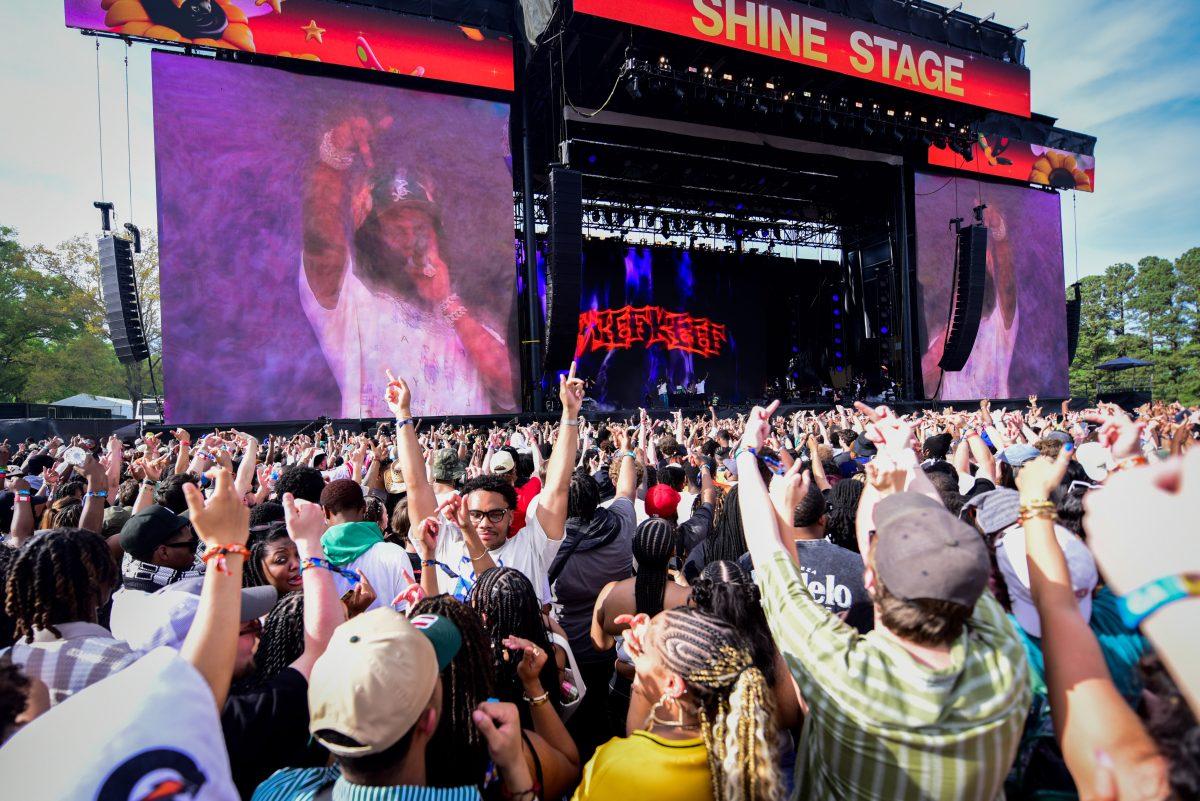 Fans put up their middle fingers with Chief Keef as he performs during the final Dreamville Festival in Dorothea Dix Park on April 5, 2025. Chief Keef performed viral hit songs "I Don't Like" and "Love Sosa" featuring his unique sound.