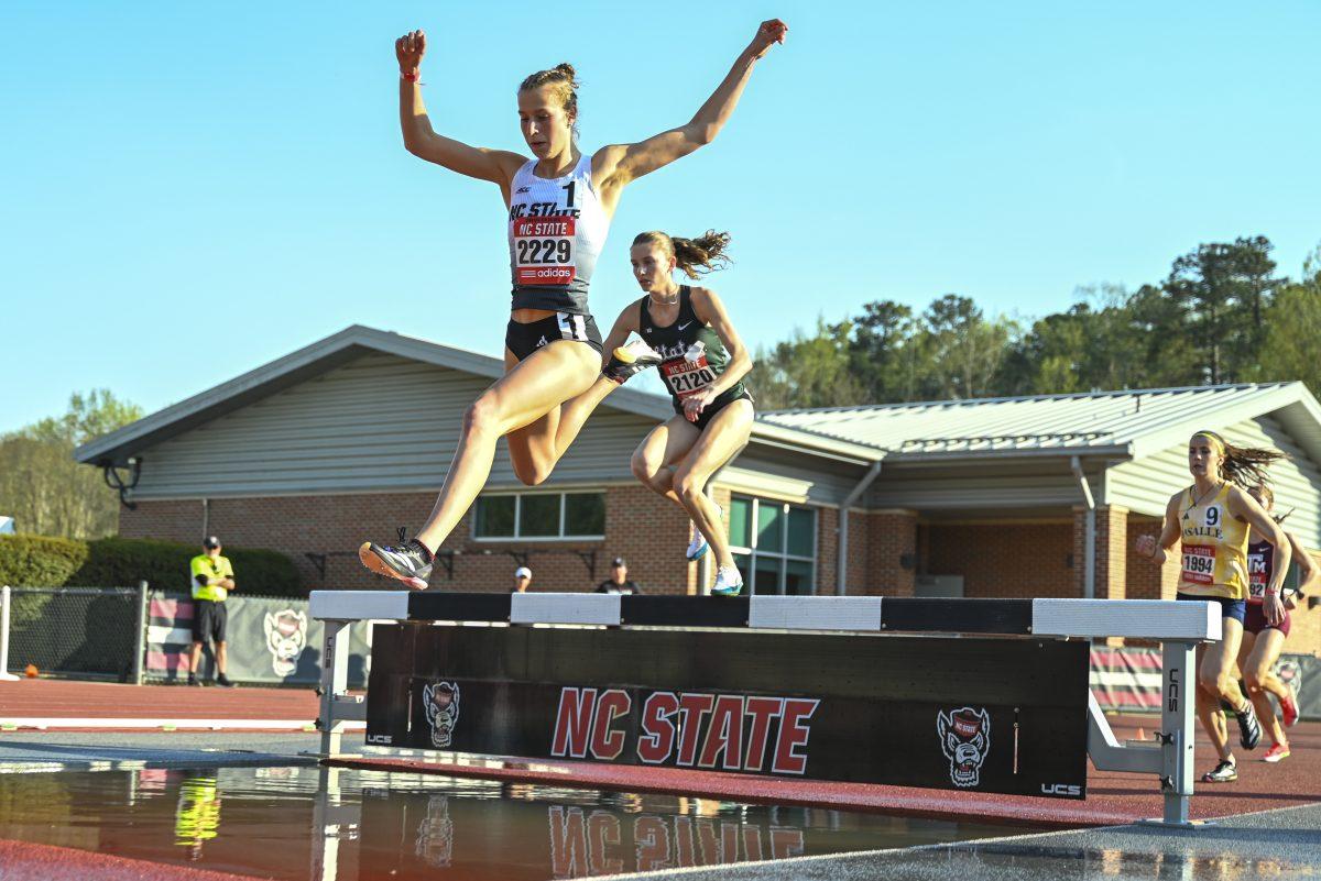 Sophomore distance runner Angelina Napoleon jumps into the water pit during the Raleigh Relays track meet at the Derr Track and Field Facility on Friday, March 28, 2025. Napoleon finished first in the 3000m steeplechase event with a time of 9:34.22, breaking the meet, facility and program record in the process.
