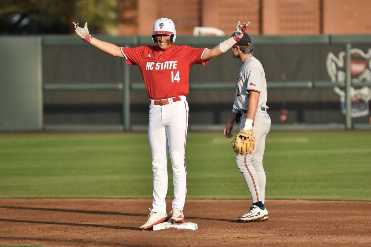 Freshman outfielder Ty Head celebrates making it to second base during the Wolfpack's home game against the Virginia Cavaliers on Doak Field at Dail Park on Friday, April 4, 2025. Head stole a home run on defense and went two for two before being walked the rest of the game from the batter's box. The Cavaliers beat the Wolfpack 8-6 to take the first game of the series.