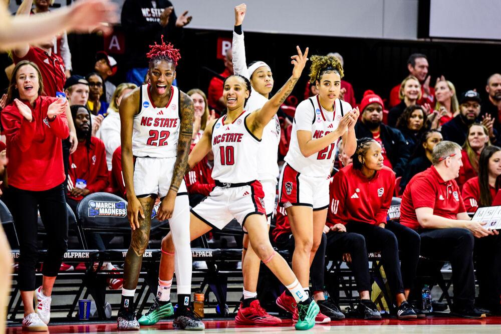 Senior guards Saniya Rivers, Aziaha James, and Madison Hayes celebrate a basket together during the second round game of the NCAA Tournament against Michigan State in Reynolds Coliseum on Monday, March 24, 2025. The Wolfpack beat the Spartans 83-49.