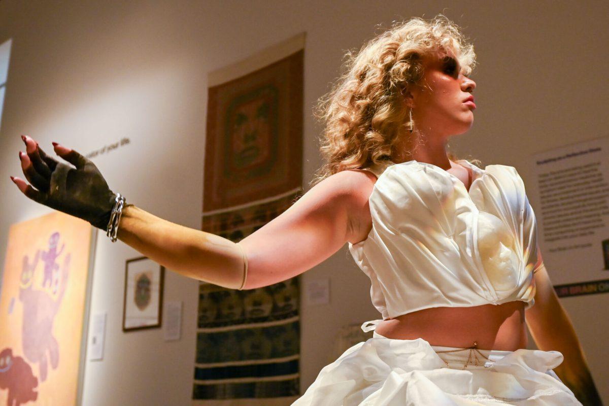 Alli Jo LaFevers, a third-year studying fashion and textile design, performs while wearing Mia Potter and Devyn Williams' piece from The Fall of Icarus during Art2Wear: Revive at the Gregg Museum of Art &amp; Design on Thursday, April 25, 2025. Instead of a traditional fashion runway, Art2Wear displayed the wearable artwork through performance art done by the artists and models.