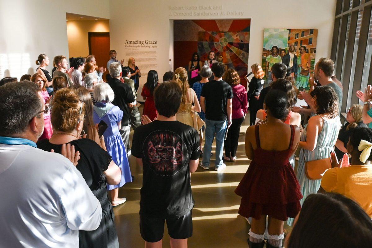 The crowd listens to Keerthi Nagapudi, a fourth-year studying design studies and co-student director, speaking with Lydia Spears, a fourth-year studying art and design and co-student director, as they introduce Art2Wear: Revive at the Gregg Museum of Art &amp; Design on Thursday, April 24, 2025. Instead of a traditional fashion runway, Art2Wear displayed the wearable artwork through performance art done by the artists and models.