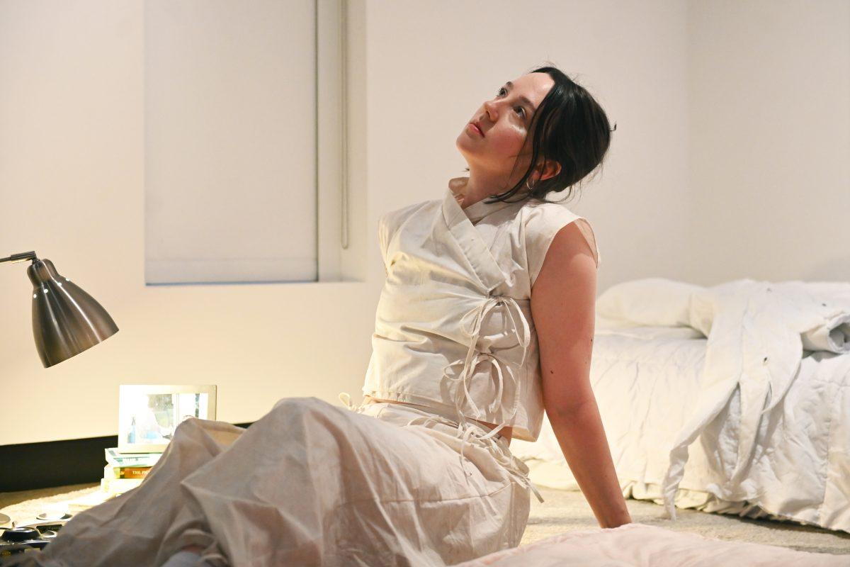 AK Stipanov, a fourth-year studying environmental design in architecture, looks upward while she models one of the three pieces that make up &#8220;Palingenesis&#8221; by Elle Newkirk during the Art2Wear: Revive! show at the Gregg Museum of Art and Design on Thursday, April 24, 2025. Newkirk&#8217;s design explores the experience of small deaths and rebirths that people experience as they grow and learn throughout their lifetime.