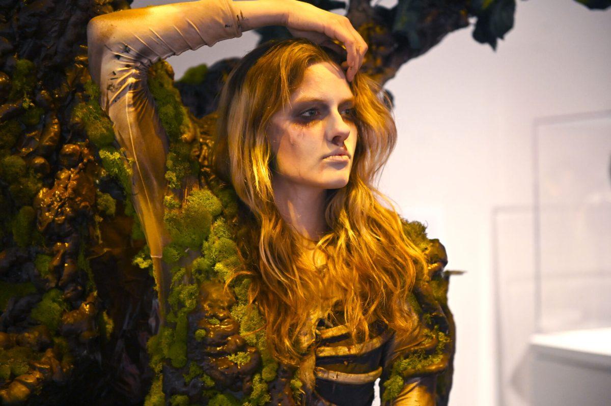 Bailey Lawson, a second-year studying graphic and experience design, models &#8220;The Return Home&#8221; by Mia Danford-Klein, a third-year studying media arts, design, and technology during the Art2Wear: Revive! show at the Gregg Museum of Art and Design. The "Revive" theme embraced the organization's history with the collaborative exhibit "Art2Wear: Through the Archives" and reinterpreted the runway show by having each designer showcase their work as a "living exhibit".