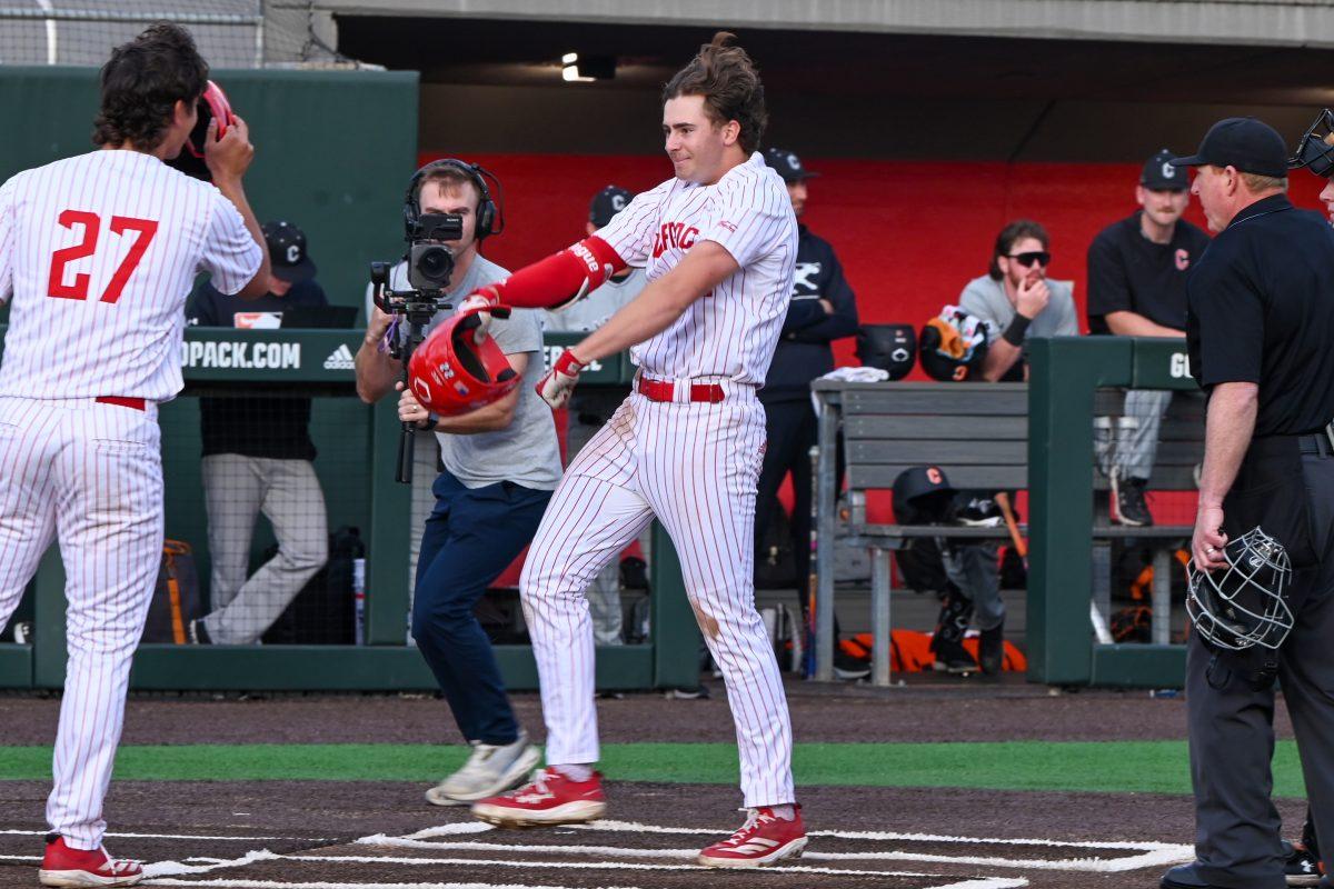 Junior outfielder Josh Hogue flexes after hitting a grand slam during the game against Campbell on Doak Field at Dail Park on Wednesday, March 5, 2025. The Wolfpack defeated the Fighting Camels 11-1. Hogue recorded one hit, a grand slam, which drove in four RBIs, along with one walk and no strikeouts.