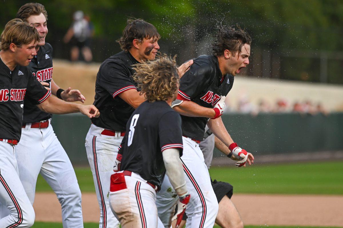 Junior outfielder Josh Hogue celebrates with his team after hitting the walk off home run during the game against Virginia on April 6, 2025 at Doak Field at Dail Park. Hogue had three RBI's and one home run. NC State beat Virginia 9-8.