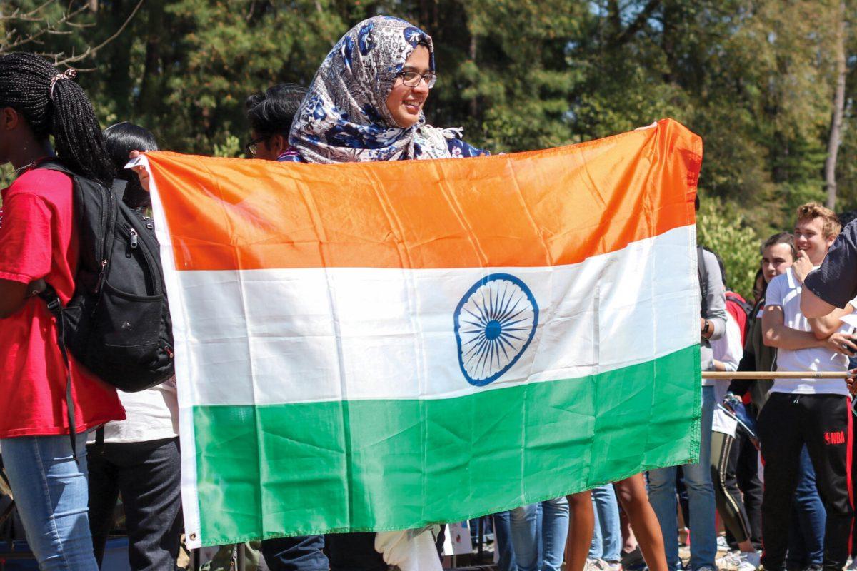 Mariyam Modan, a second-year studying human biology holds up a flag of India for a photo at the international festival at Stafford Commons on Friday, March 29, 2019.