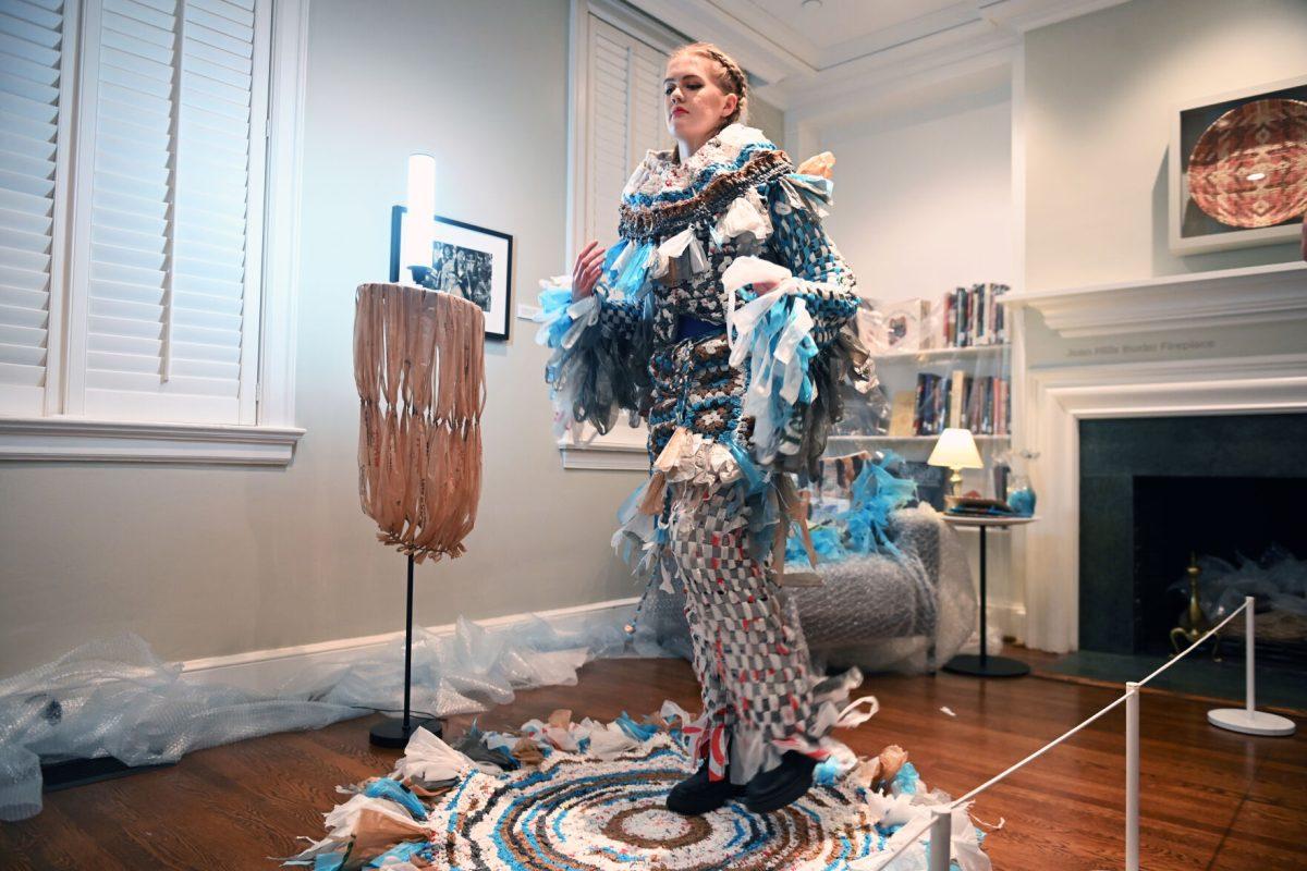 Meghan Mersch, a 2024 graduate of the graphic and experience design program, models her piece &#8220;Baggage&#8221; during the Art2Wear: Revive! show at the Gregg Museum of Art and Design on Thursday, April 24, 2025. Mersch&#8217;s design aims to shed light on overconsumption and waste, and it is made entirely out of plastic grocery bags.