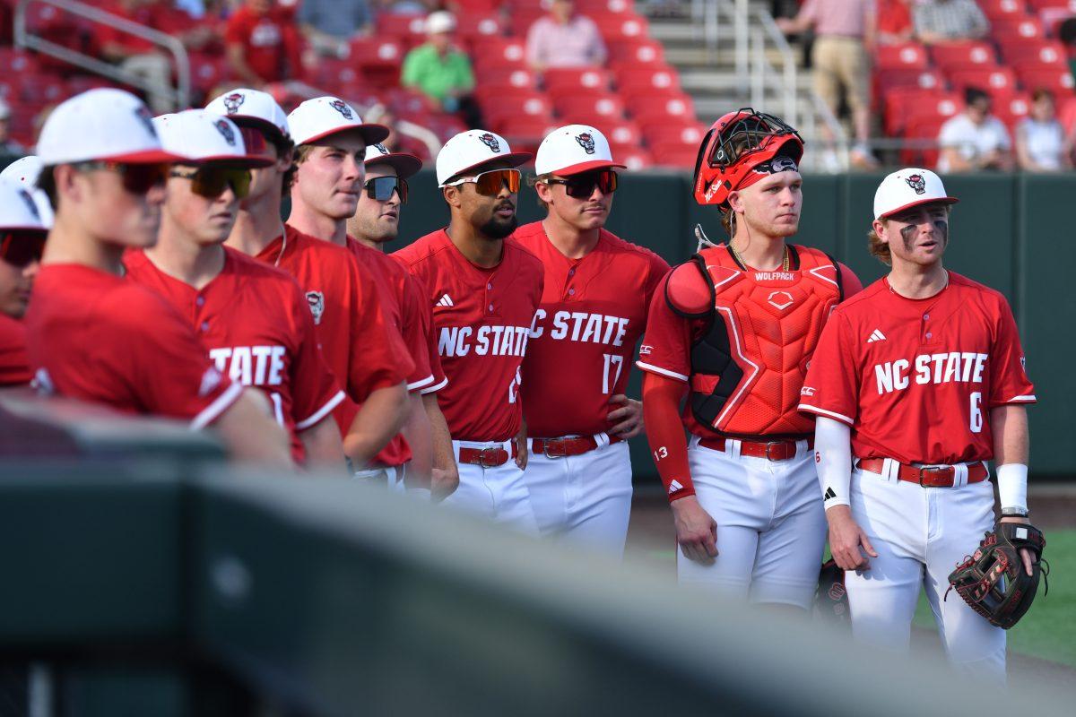 The NC State baseball team watches the big screen in the outfield before their game against Virginia on Doak Field at Dail Park on Friday, April 4, 2025. Virginia beat NC State 8-6 to take the first game of the series. The Wolfpack would go on to win games two and three to take the series.