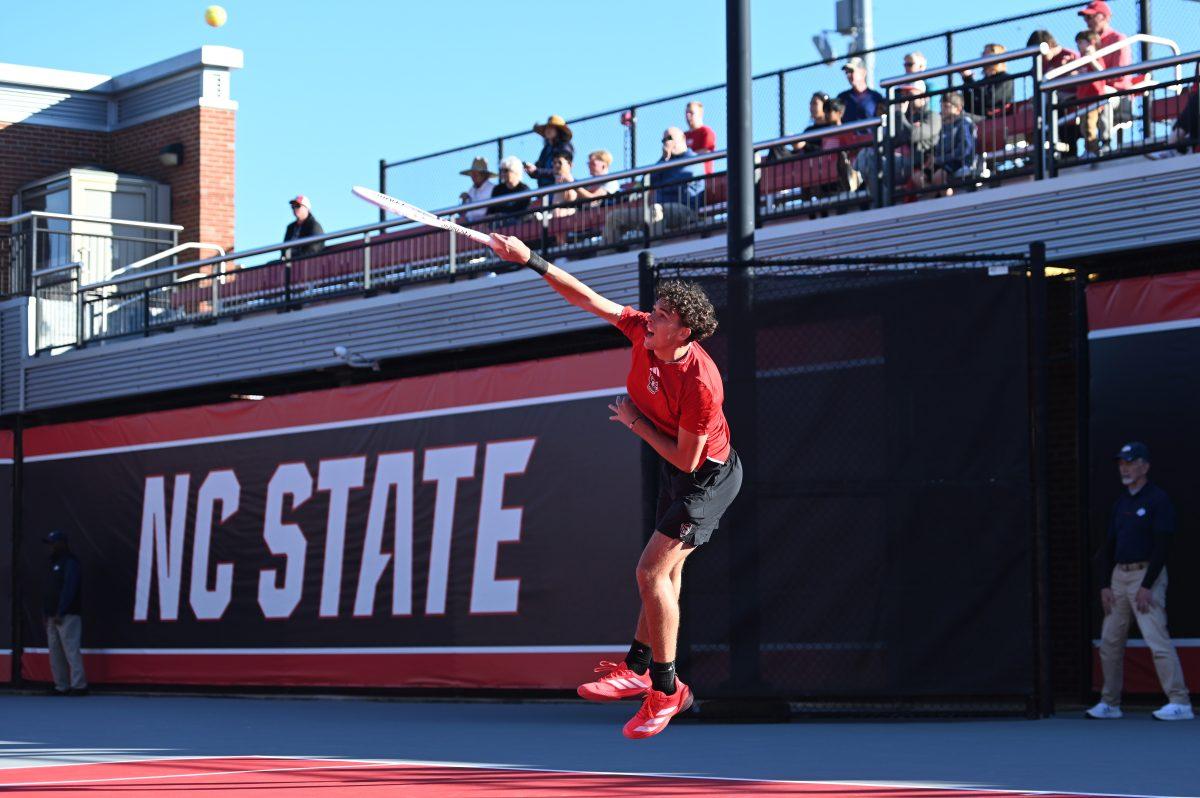 Redshirt freshman Jules Leroux serves the ball during his doubles match with senior Luca Staeheli versus California at J.W. Isenhour tennis center on Friday, Feb. 28, 2025. Leroux and Staeheli's doubles match was unfinished. The Wolfpack beat the Golden Bears 4-2.