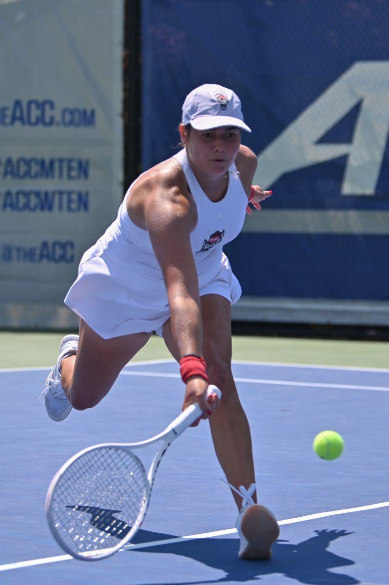 Freshman Mia Slama lunges for a low ball during the quarterfinal match of the ACC Championship against Notre Dame at Cary Tennis Park on Friday, April 18, 2025. Slama won her singles match 2-0. The Wolfpack defeated the Fighting Irish 4-1.