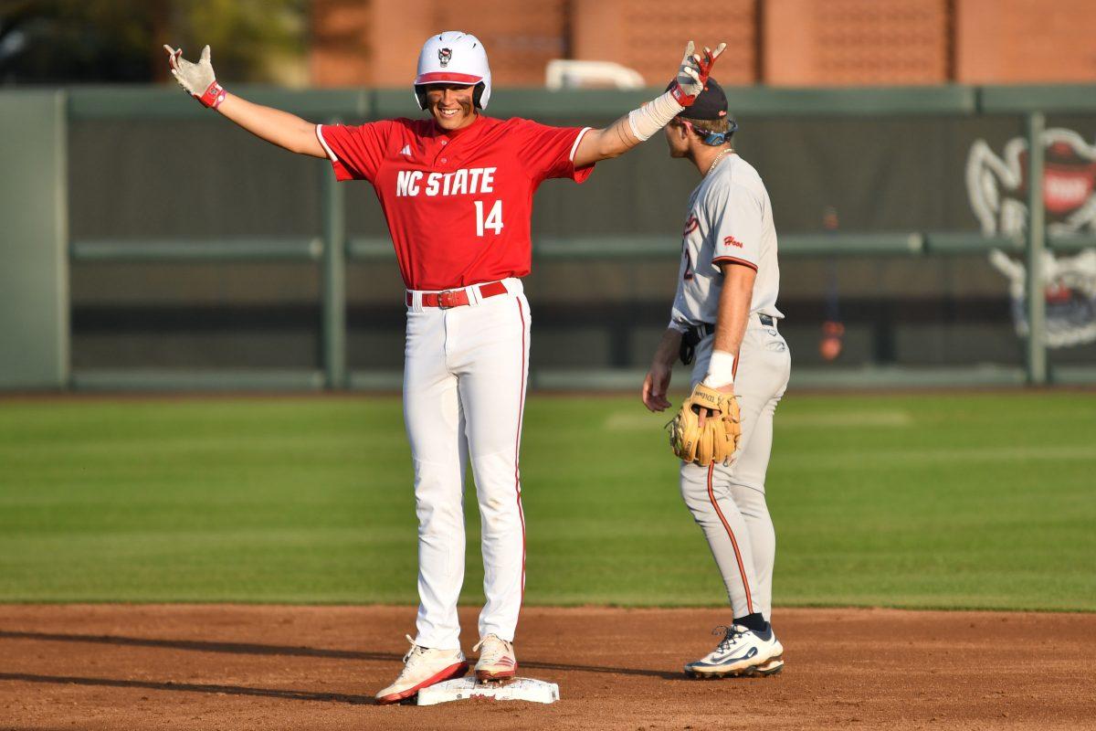 Freshman outfielder Ty Head celebrates making it to second base after an error by the Virginia infield during the Wolfpack's home game against the Virginia Cavaliers on Doak Field at Dail Park on Friday, April 4, 2025. Head stole a home run and hit twice and was walked twice on four at bats. The Wolfpack lost to the Cavaliers 8-6.