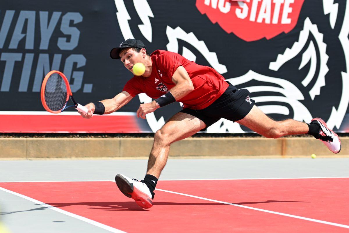 Senior Luca Staeheli lunges to return the ball during his doubles match with redshirt freshman Jules Leroux versus SMU at J.W. Isenhour Tennis Center on Sunday, April 6, 2025. Staeheli and Leroux won their doubles match 6-4. The Wolfpack beat the Mustangs 4-1.