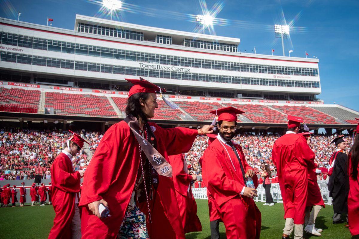 Nicol&#225;s Galvez, a fourth-year student graduating with a degree in zoology, playfully pulls on the tassel of Bilal Adam Malik, a fourth-year graduating with a degree in zoology, during the University Commencement ceremony in Carter-Finley Stadium on Saturday, May 3, 2025. NC State conferred 7,234 degrees at the ceremony, including 5,079 bachelor&#8217;s, 1,783 master&#8217;s, 306 doctoral, and 66 associate degrees.