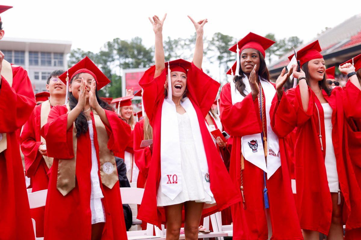 Lauren Pountnay, a criminology school graduate, puts her hands up the air holding up the "wolfie" hand sign during the University Commencement ceremony in Carter-Finley Stadium on Saturday, May 3, 2025. Over 5,079 students graduated with Bachelor's degrees at NC States 2025 Spring Commencement Ceremony.