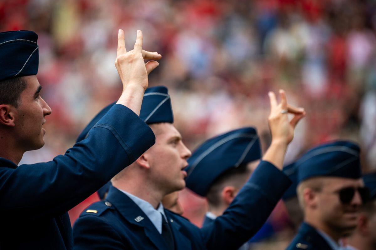 Graduating cadets throw up "Wolfies" during the University Commencement ceremony in Carter-Finley Stadium on Saturday, May 3, 2025. NC State conferred 7,234 degrees at the ceremony, including 5,079 bachelor&#8217;s, 1,783 master&#8217;s, 306 doctoral, and 66 associate degrees.