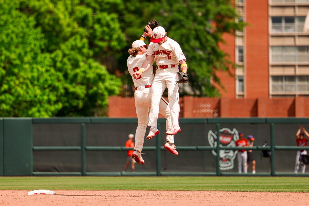 Junior infielder Matt Heavner and Sophomore infielder Luke Nixon celebrate the win during the annual "Victory over Cancer" game at Doak Field at Dail Park on Sunday, April, 27, 2025. NC State beat Clemson 4-1.