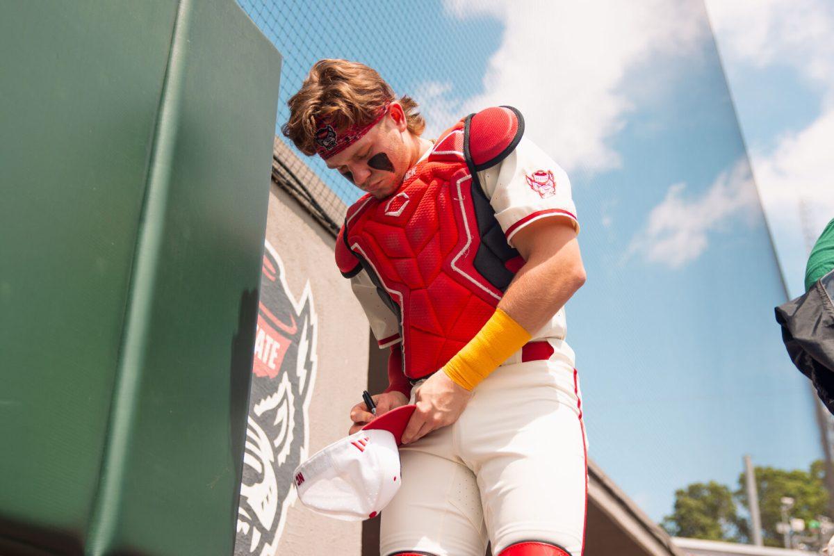 Sophomore catcher Alex Sosa signs a hat for a fan before the 2nd annual "Victory over Cancer" game at Doak Field at Dail Park on Sunday, April, 27, 2025. Sosa hit two homers during the series versus Clemson. NC State beat Clemson 4-1.
