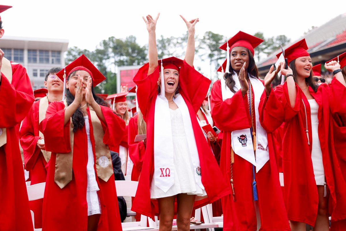 Lauren Pountnay, a criminology school graduate, puts her hands up the air holding up the "wolfie" hand sign during the University Commencement ceremony in Carter-Finley Stadium on Saturday, May 3, 2025. Over 5,079 students graduated with Bachelor's degrees at NC States 2025 Spring Commencement Ceremony.