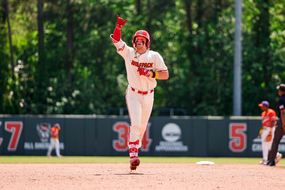 Sophomore catcher Alex Sosa holds up the "wolfie" sign during the annual "Victory over Cancer" game at Doak Field at Dail Park on Sunday, April, 27, 2025. Sosa hit two homers during the series versus Clemson. NC State beat Clemson 4-1.
