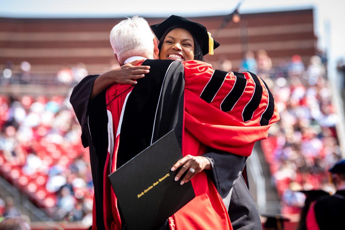 Jillian Cross, a doctoral graduate studying educational leadership, policy, and human development, embraces Chancellor Randy Woodson after receiving her doctor of philosophy degree during the University Commencement ceremony in Carter-Finley Stadium on Saturday, May 3, 2025. More than 6,800 students turned their tassels at NC State's 2025 spring commencement ceremony.