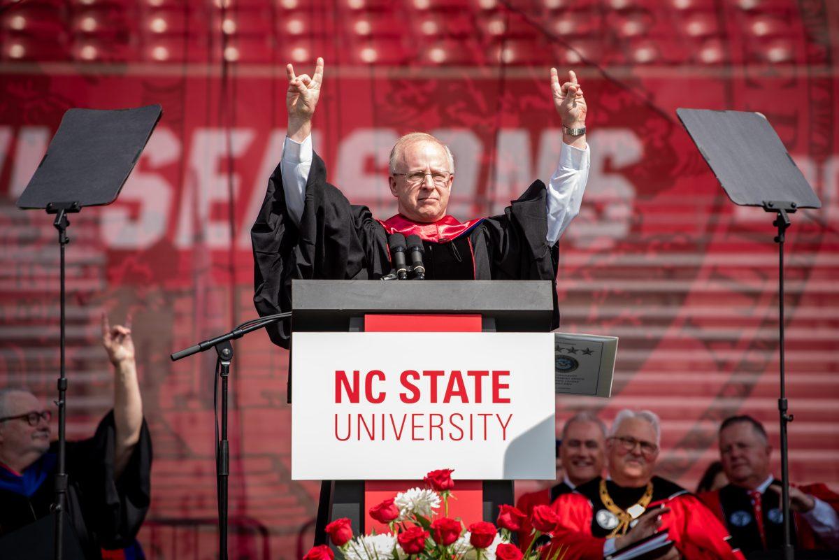 Honorary commencement speaker Admiral Daryl L. Caudle, commander of the United States Fleet Forces Command, throws up "Wolfies" to the graduating class of 2025 during the University Commencement ceremony in Carter-Finley Stadium on Saturday, May 3, 2025. NC State conferred 7,234 degrees at the ceremony, including 5,079 bachelor&#8217;s, 1,783 master&#8217;s, 306 doctoral, and 66 associate degrees.