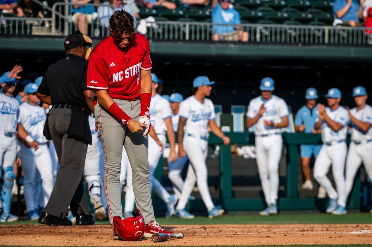 Freshman outfielder Ty Head takes off his batting gloves after striking out during the game against UNC in Boshamer Stadium on Thursday, May 8, 2025. The Tar Heels beat the Wolfpack 8-1.