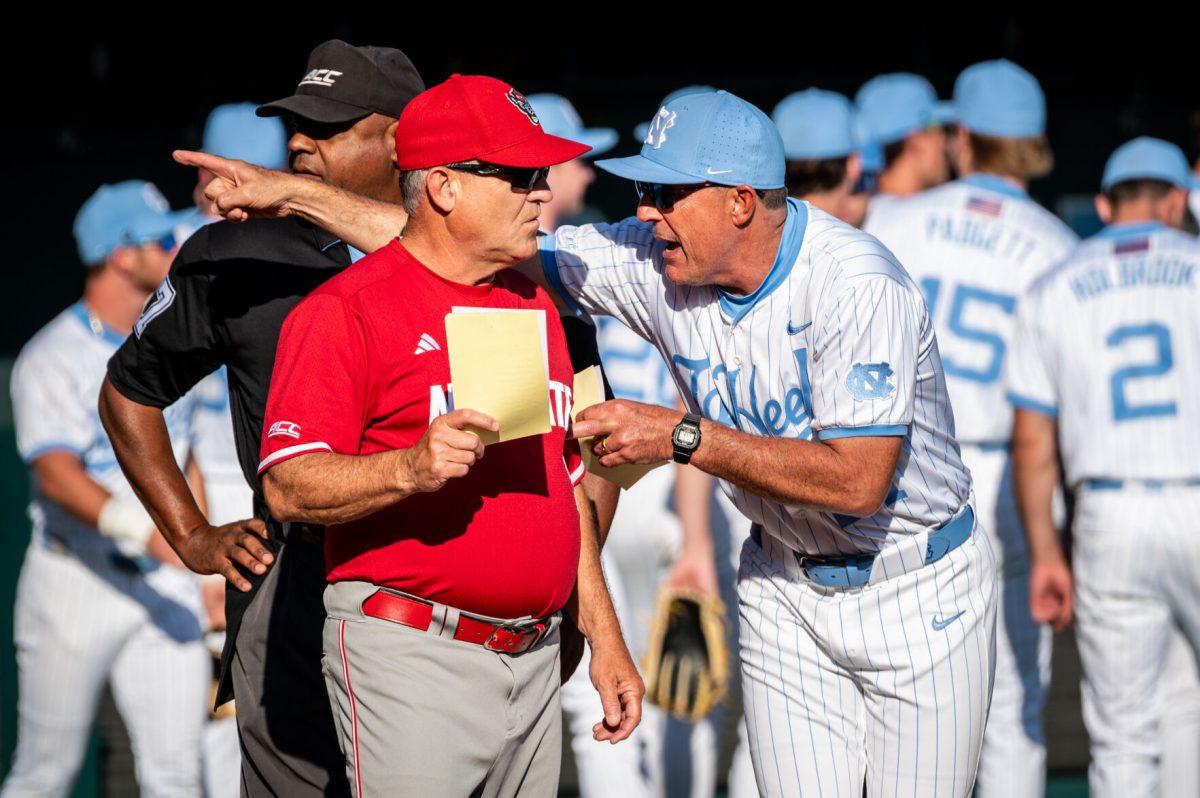 Head coach Elliot Avent talks with UNC head coach Scott Forbes before the game against UNC in Boshamer Stadium on Thursday, May 8, 2025. The Tar Heels beat the Wolfpack 8-1.