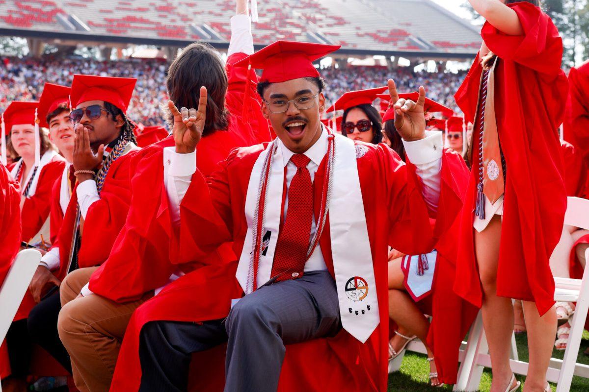 Lawrence Windsor Kee, a Management school graduate, holds up "wolfie" hand signs while smiling before the University Commencement ceremony in Carter-Finley Stadium on Saturday, May 3, 2025. Over 5,079 students graduated with Bachelor's degrees at NC States 2025 Spring Commencement Ceremony.
