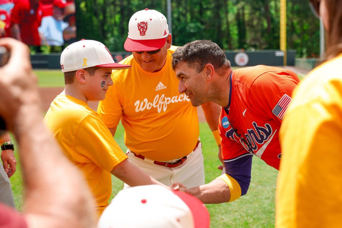 Pediatric cancer survivor Brady's brother shakes the hand of Clemson head coach Erik Bakich before the 2nd annual "Victory over Cancer" game at Doak Field at Dail Park on Sunday, April, 27, 2025. The game raised 55,000 so far for funding for Pediatric research. NC State beat Clemson 4-1.