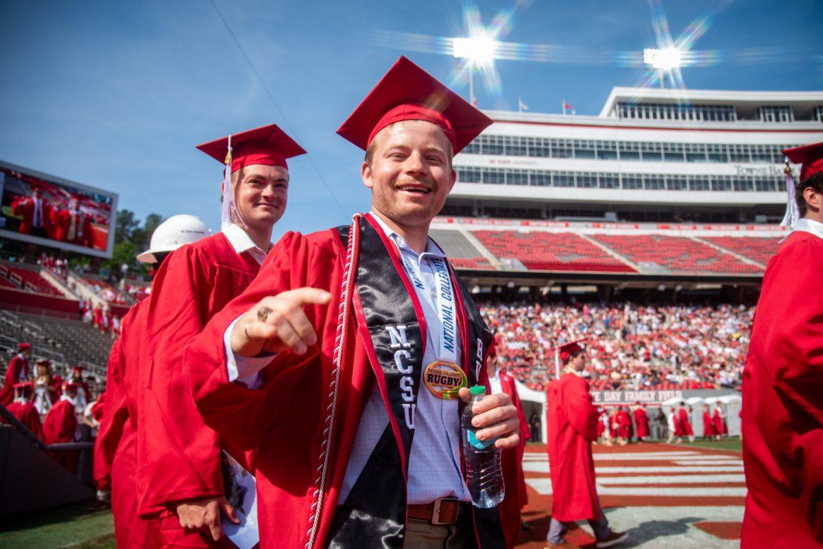 Damian Piasecki, a fourth-year graduating with a degree in civil engineering, smiles while walking onto the field during the University Commencement ceremony in Carter-Finley Stadium on Saturday, May 3, 2025. NC State conferred 7,234 degrees at the ceremony, including 5,079 bachelor&#8217;s, 1,783 master&#8217;s, 306 doctoral, and 66 associate degrees.