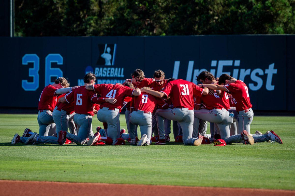 The NC State baseball team joins together in prayer before the game against UNC in Boshamer Stadium on Thursday, May 8, 2025. The Tar Heels beat the Wolfpack 8-1.