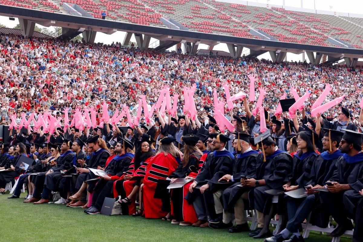 Veterinary school graduates smile while holding inlflated veterinary gloves up during the University Commencement ceremony in Carter-Finley Stadium on Saturday, May 3, 2025. Over 5,079 students graduated with Bachelor's degrees at NC States 2025 Spring Commencement Ceremony.
